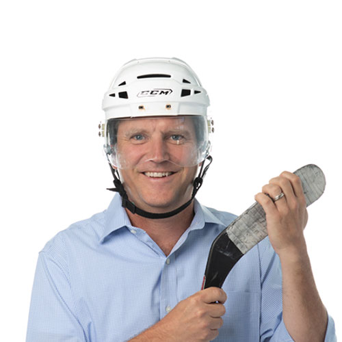 tom witt team member at orases with a hockey stick and hockey helmet