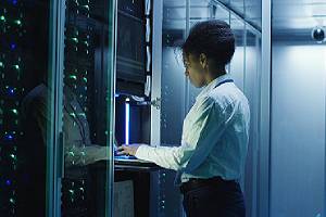 An IT technician checking data server in a data center.