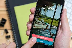 Person logging into the Airbnb custom web application