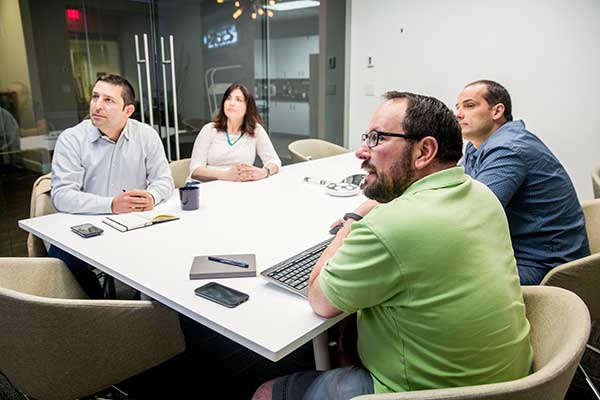 Orases employees reviewing their custom CRM software project