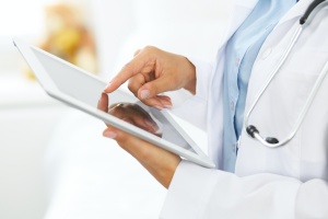 women doctor carrying tablet using a Custom Patient Portal