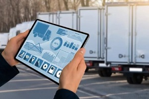 person with tablet in hand with trucks schedules