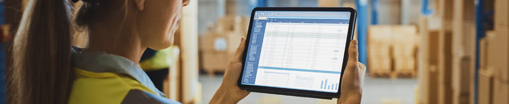 warehouse woman holding a tablet with data on operations