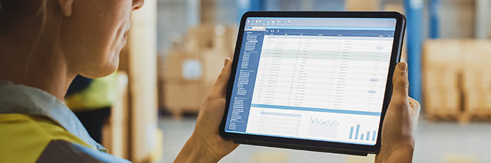 warehouse woman holding a tablet with data on operations