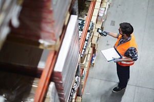 warehouse worker scanning inventory and taking notes