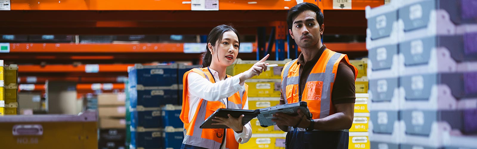 supply chain managers inspecting an outbound load and pointing to an error found using supply chain management software