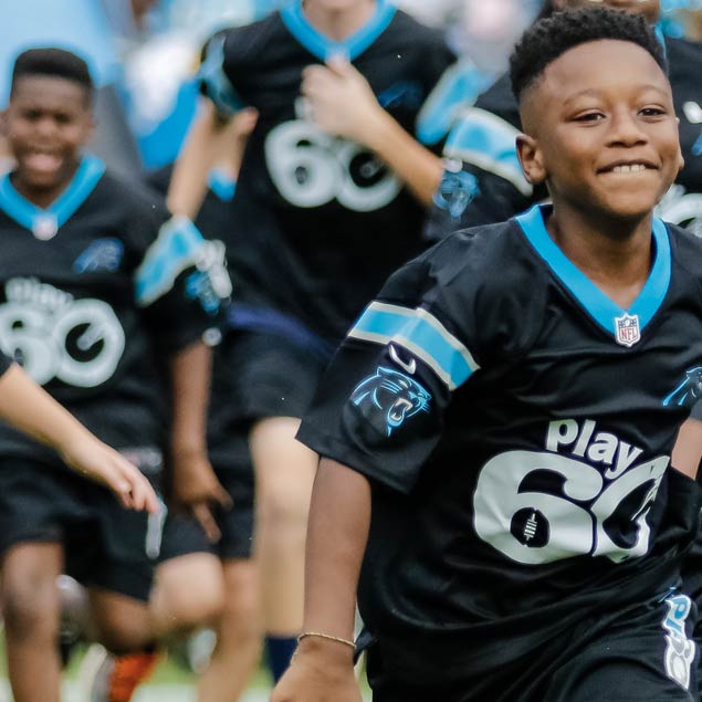 Children in NFL grant foundation jerseys