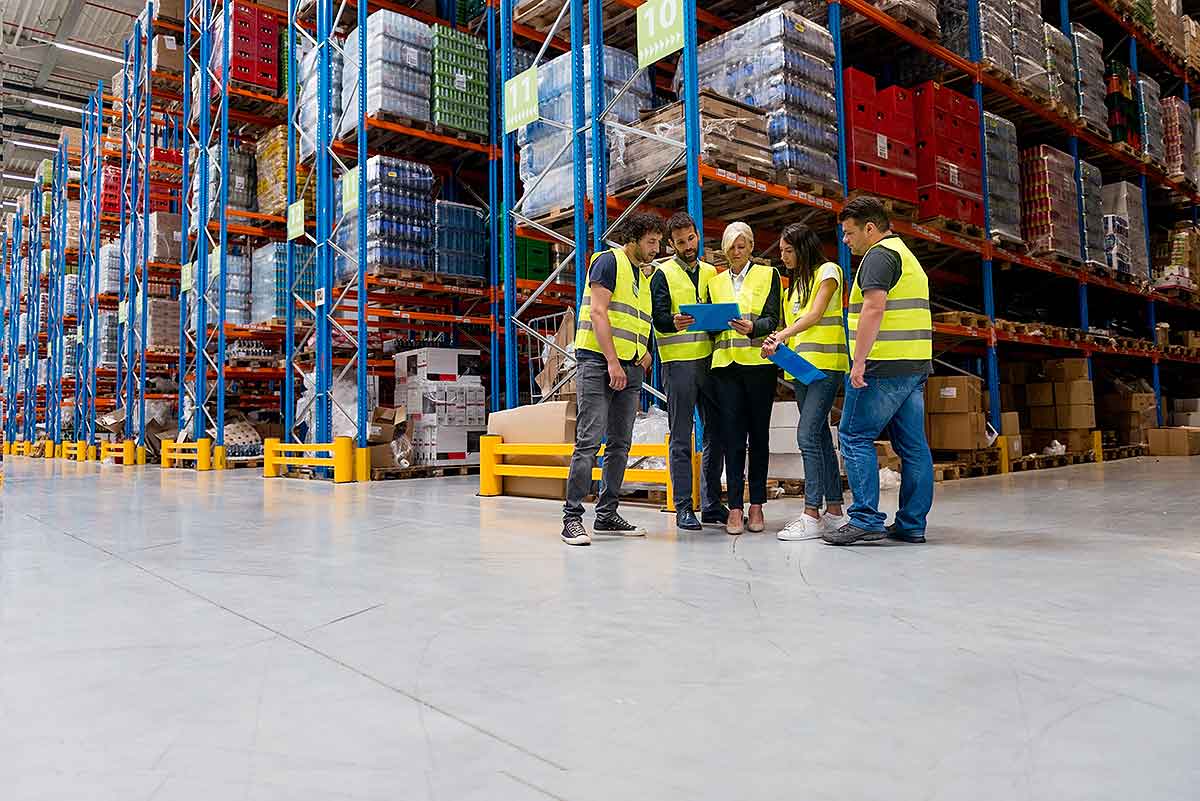 warehouse employees reviewing their inventory