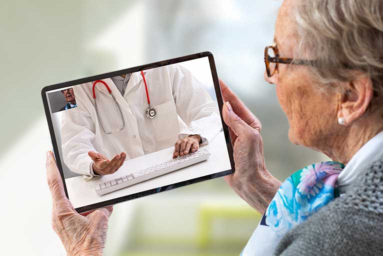 Older woman using custom home patient software