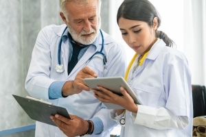 healthcare professionals using data analytics software to review a patients results