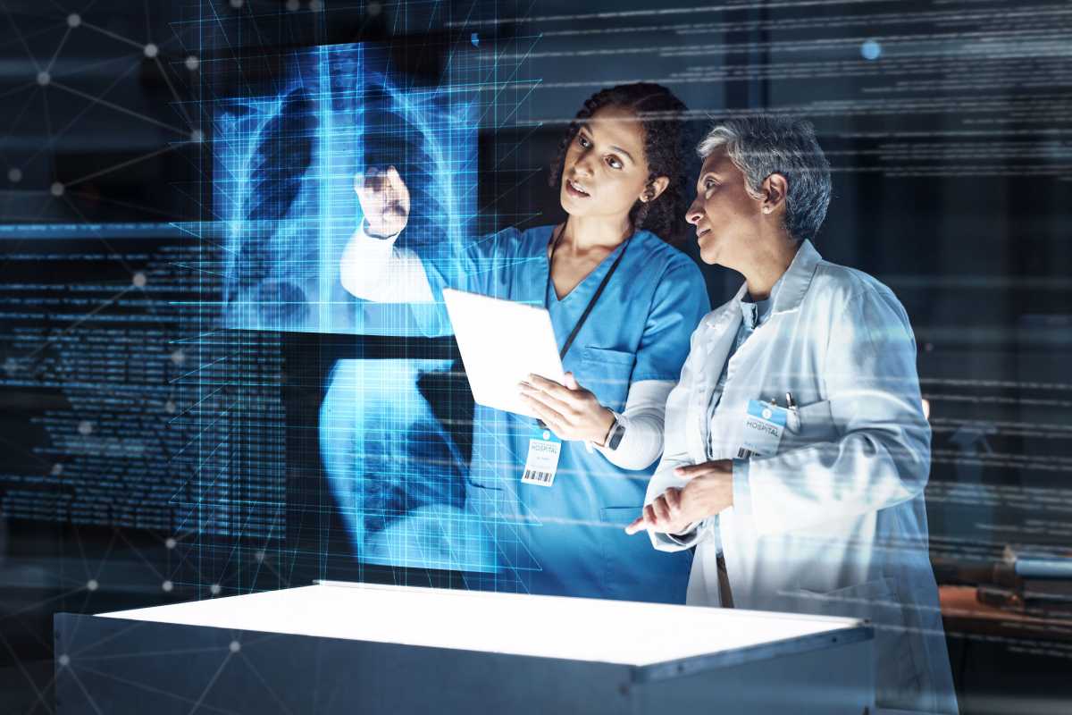two medical professionals using data analytics in healthcare to review the condition of a patients lung