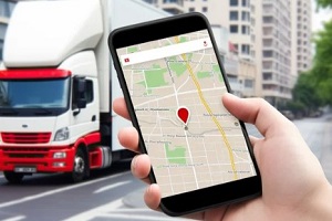 person checking location in map with truck in background