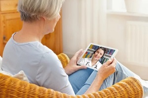 doctor giving online consultation to an old lady