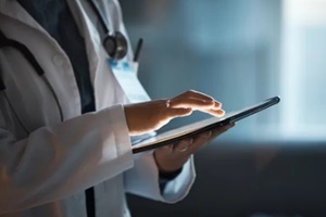 digital tablet and doctor hands for hospital innovation