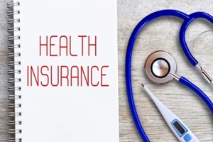 health insurance on notebooks or paper in office desk