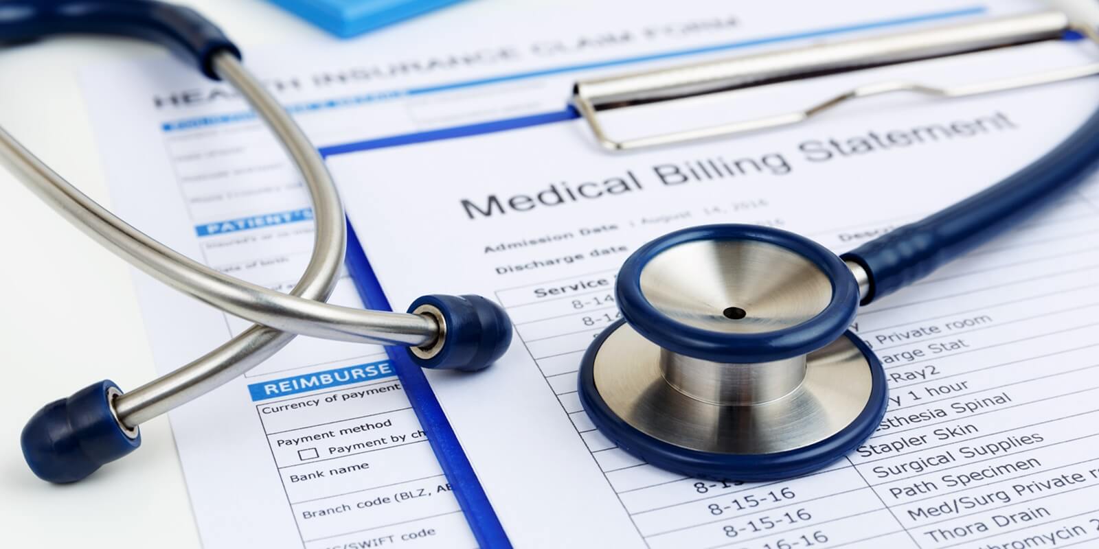stethoscope on medical bills and health insurance claim form