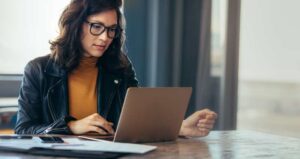 woman working on customer portal on laptop