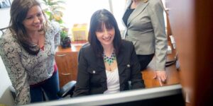 orases female staff members working on a system