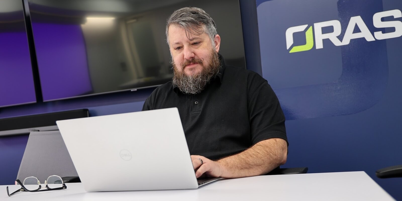 beard man working on a laptop